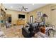 Living room area featuring tile floors, ceiling fan, zebra art and leather sofa at 403 Indian Meadow Ct, Wimauma, FL 33598