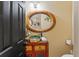 Eclectic powder room with colorful vanity and decorative mirror at 403 Indian Meadow Ct, Wimauma, FL 33598