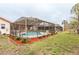 View of the screened in pool in the backyard, and view of the outdoor kitchen at 430 Westford, Palm Harbor, FL 34683