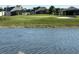 Picturesque view of the lush golf course and calm lake, showcasing a beautiful landscape at 43314 Water Bird Way # 6712, Punta Gorda, FL 33982