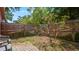 Private fenced backyard featuring a small flowering tree and stone patio at 4424 19Th N St, St Petersburg, FL 33714