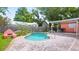A kidney-shaped pool offers a refreshing escape in this fenced backyard with mature landscaping at 4424 19Th N St, St Petersburg, FL 33714