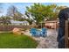 Inviting backyard featuring a sparkling pool, brick fire pit, and cozy blue Adirondack chairs, perfect for outdoor relaxation at 4424 19Th N St, St Petersburg, FL 33714