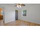 Bright bedroom with wood-look floors, closet with curtain, window to backyard at 4424 19Th N St, St Petersburg, FL 33714
