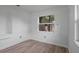 Bright bedroom with white walls, modern floors, and natural light from the window at 4424 19Th N St, St Petersburg, FL 33714