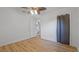 Neutral bedroom with wood-look floors, a fan, and a view into a bathroom and closet at 4424 19Th N St, St Petersburg, FL 33714