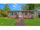 Charming brick home featuring a well-manicured lawn and bright white front door at 4424 19Th N St, St Petersburg, FL 33714
