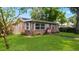 Beautiful brick home with green lawn and a walkway leading to the front door at 4424 19Th N St, St Petersburg, FL 33714