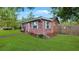 Charming brick home featuring a well-maintained lawn and mature landscaping at 4424 19Th N St, St Petersburg, FL 33714