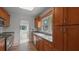 A kitchen featuring wood cabinets, stone countertops, stainless steel appliances, and tile floor at 4424 19Th N St, St Petersburg, FL 33714