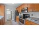 A kitchen featuring wood cabinets, stone countertops, stainless steel appliances, and tile floor at 4424 19Th N St, St Petersburg, FL 33714