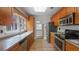 A kitchen featuring wood cabinets, stone countertops, stainless steel appliances, and tile floor at 4424 19Th N St, St Petersburg, FL 33714