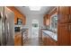 A kitchen featuring wood cabinets, stone countertops, stainless steel appliances, and tile floor at 4424 19Th N St, St Petersburg, FL 33714