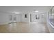 Light-filled living space features neutral tile flooring, recessed lighting, and bright white walls at 4424 19Th N St, St Petersburg, FL 33714
