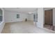 Bright living room features neutral tile flooring, fresh white walls, and French doors leading to outdoor spaces at 4424 19Th N St, St Petersburg, FL 33714