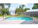 Private backyard pool featuring a brick patio, shed, lush greenery, and mature trees at 4424 19Th N St, St Petersburg, FL 33714