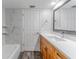 This remodeled bathroom features a wood vanity, white countertop and marble tile in the shower at 4714 Kemble Ct, Tampa, FL 33624