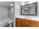 Updated bathroom with a wood vanity, white countertop and marble tile in the shower and floors at 4714 Kemble Ct, Tampa, FL 33624