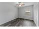 This spacious bedroom features gray walls, wood-look flooring, large window and ample closet space at 4714 Kemble Ct, Tampa, FL 33624