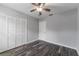 This bedroom features gray walls, wood-look flooring, a ceiling fan and ample closet space at 4714 Kemble Ct, Tampa, FL 33624