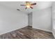 Bedroom with wood-look tile flooring, a ceiling fan, and a closet at 4714 Kemble Ct, Tampa, FL 33624