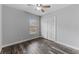 This bedroom features neutral walls, wood-look flooring, large window and ample closet space at 4714 Kemble Ct, Tampa, FL 33624