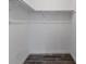 Empty closet with white shelving and wood-look tile flooring at 4714 Kemble Ct, Tampa, FL 33624