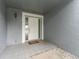Up-close view of the front door, framed by decorative molding, and a stylish outdoor light fixture at 4714 Kemble Ct, Tampa, FL 33624