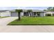 Well-maintained house featuring mature landscaping, manicured lawn, and neutral exterior paint at 4714 Kemble Ct, Tampa, FL 33624