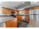 A kitchen showcasing modern appliances, wooden cabinets, and granite countertops at 4714 Kemble Ct, Tampa, FL 33624