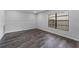 Bright living room with wood-look flooring and large window, creating a cozy atmosphere at 4714 Kemble Ct, Tampa, FL 33624