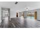 Spacious living room with tile floors, ceiling fans, and sliding glass doors to the pool at 4714 Kemble Ct, Tampa, FL 33624