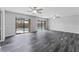 Large, airy living room with views of the outdoor pool through sliding glass doors at 4714 Kemble Ct, Tampa, FL 33624