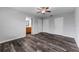 A spacious main bedroom featuring wood-look flooring and a ceiling fan and ensuite bathroom at 4714 Kemble Ct, Tampa, FL 33624