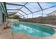 A large screened-in pool is surrounded by concrete and covered with a transparent screened enclosure at 4714 Kemble Ct, Tampa, FL 33624