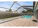 Screened-in pool and patio surrounded by a wood fence at 4714 Kemble Ct, Tampa, FL 33624