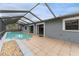 Screened-in pool featuring a tiled patio and a ladder for entry at 4714 Kemble Ct, Tampa, FL 33624