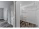 A functional walk-in closet with modern organizing system featuring metal shelving and dark wood-look flooring at 4714 Kemble Ct, Tampa, FL 33624
