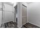 A walk-in closet with built-in shelving that leads to a shuttered closet and bedroom at 4714 Kemble Ct, Tampa, FL 33624