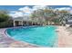 Inviting community pool area with lounge chairs and a covered pavilion for relaxation at 4806 Pond Ridge Dr, Riverview, FL 33578