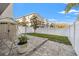 Cozy backyard featuring a patio area, green space, storage shed, and a white privacy fence at 4859 W Prescott St, Tampa, FL 33616