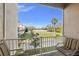 Balcony featuring seating, an outdoor view of neighborhood, and a clear, sunny sky at 4859 W Prescott St, Tampa, FL 33616
