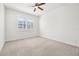 Bright bedroom featuring neutral walls and carpet with natural light and ceiling fan at 4859 W Prescott St, Tampa, FL 33616