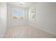 Bright, empty bedroom with tile flooring, white walls, baseboards, and windows with shutter-style blinds at 4859 W Prescott St, Tampa, FL 33616