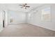 Spacious bedroom featuring neutral walls and carpet, natural light, and a door to the balcony at 4859 W Prescott St, Tampa, FL 33616