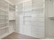 Walk-in closet featuring custom shelving and drawers, optimizing storage and organization at 4859 W Prescott St, Tampa, FL 33616