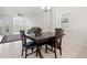 An inviting dining area with a dark wood table, chair set, and bright white walls for memorable meals at 4859 W Prescott St, Tampa, FL 33616