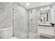 Modern bathroom featuring a marble tiled shower with glass door and contemporary vanity at 5200 Dove Dr, New Port Richey, FL 34652