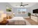 Cozy bedroom features neutral tones, a ceiling fan, and a bright window for lots of natural light at 5200 Dove Dr, New Port Richey, FL 34652