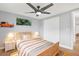 Cozy bedroom features a ceiling fan, modern decor, and two bedside tables with lamps at 5200 Dove Dr, New Port Richey, FL 34652